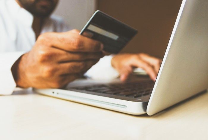 Person with credit card and laptop