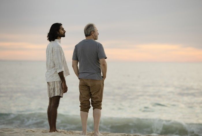Two men staring out at the ocean