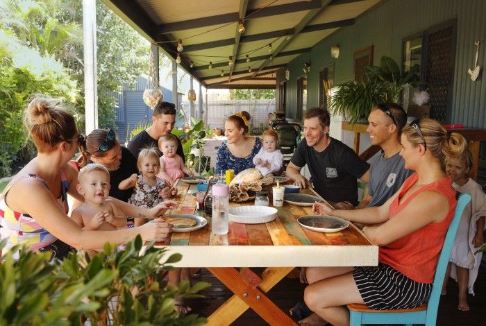 a family sitting around an outdoor table