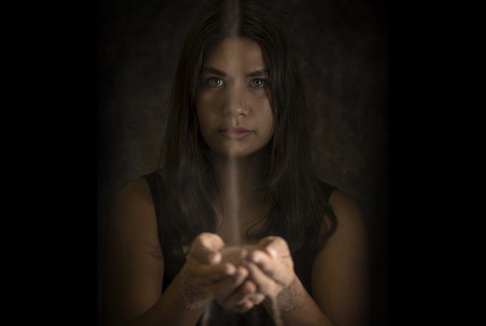 Hero image showing the lead actor with sand falling from their hands