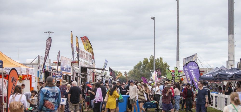 People walking around town festival/fare