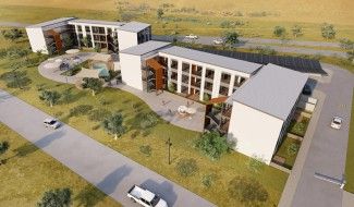 Aerial rendering of a modern apartment complex with landscaped courtyards, walking paths, solar panels, and surrounding open space.